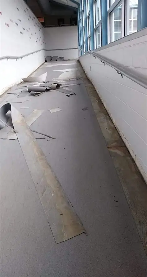 Commercial flooring being removed from an institutional corridor